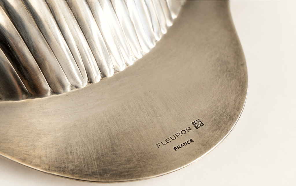Close-up of Fleuron France maker's mark on vintage silver-plated scallop dish