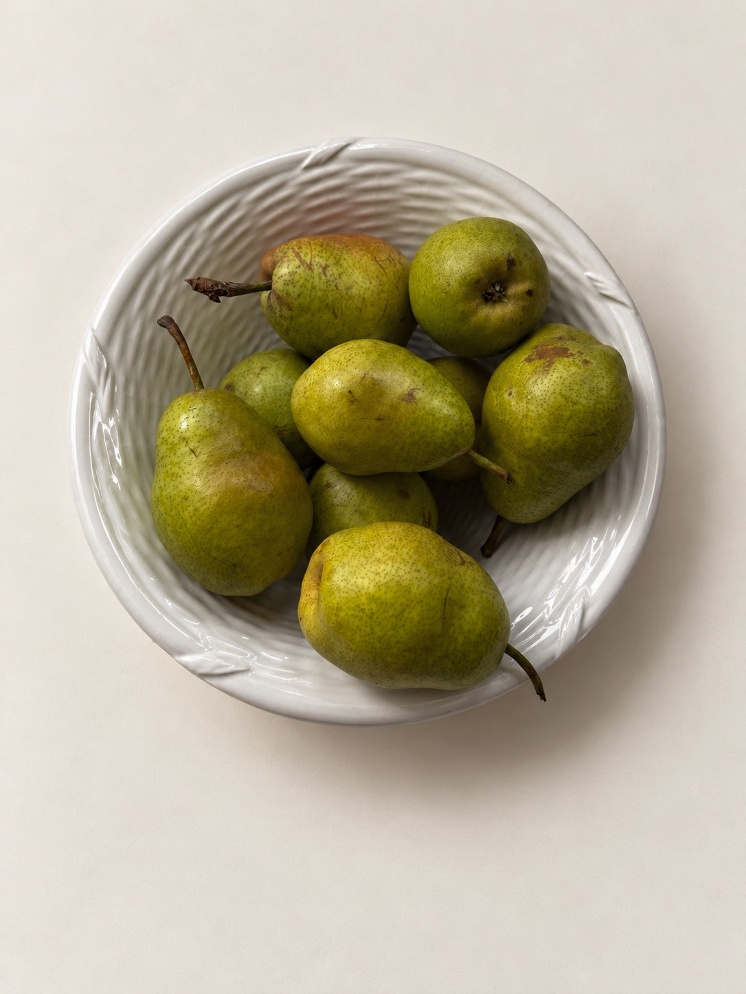 Vintage white ceramic woven bowl styled with green pears