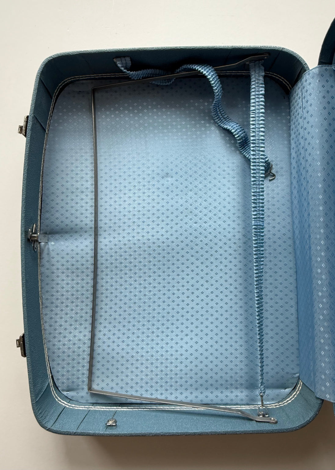 Vintage blue luggage interior with patterned lining