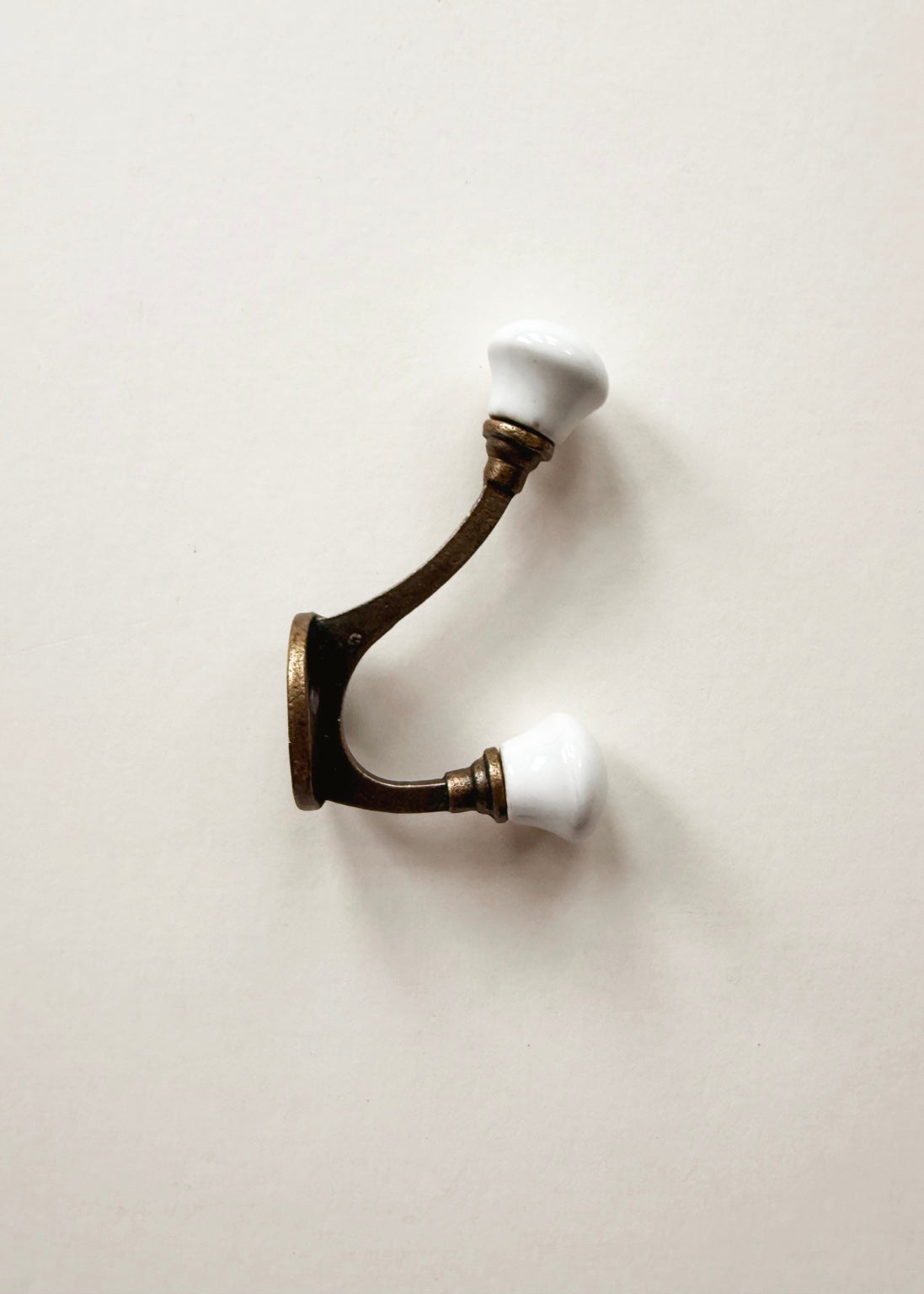 Vintage brass double wall hook with white porcelain knobs