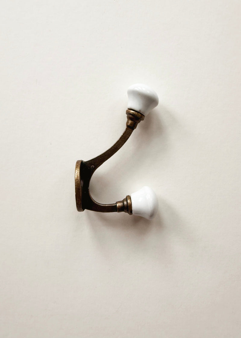 Vintage brass double wall hook with white porcelain knobs