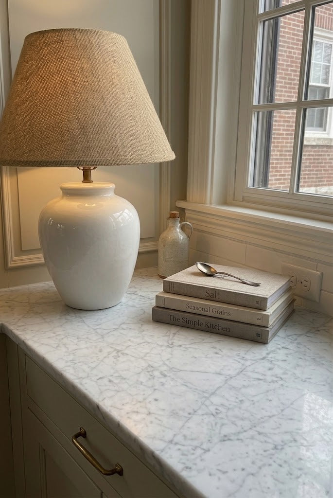 Vintage ceramic table lamp with textured shade styled on a marble kitchen counter