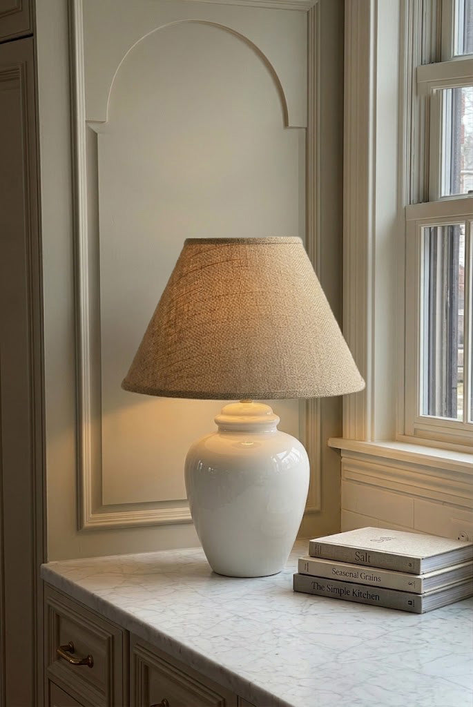 Vintage white ceramic table lamp styled in a warm neutral interior