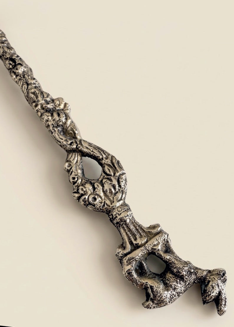 Close-up detail of ornate vintage Italian silver plated baby spoon