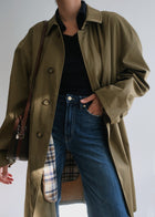 Vintage military green below-knee raincoat styled on a 5 foot 11 model