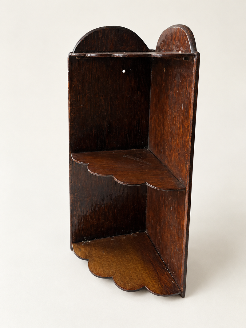 Vintage scalloped wooden corner shelf on clean off-white background